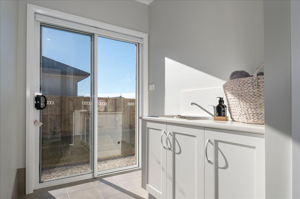 Home Design Internal. Laundry. Laundry Tub with bench. Sliding Glass Door.