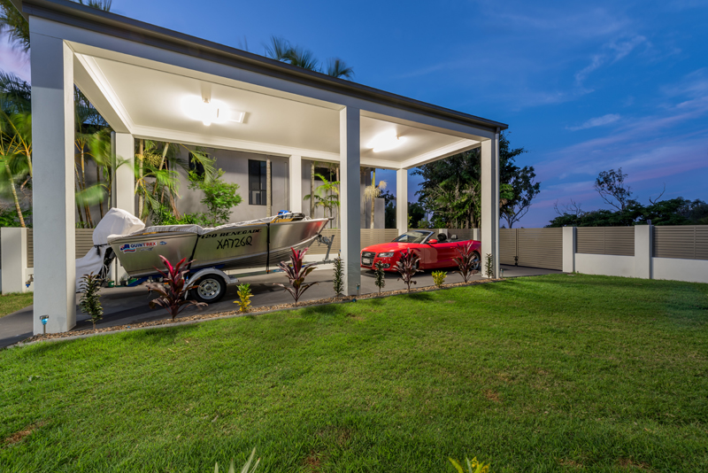 Home Design External. Night. Car port with boat and car.