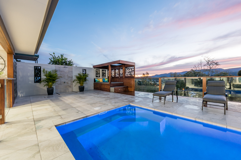 Home Design External. From under Alfresco looking out to pool and view. Dusk.