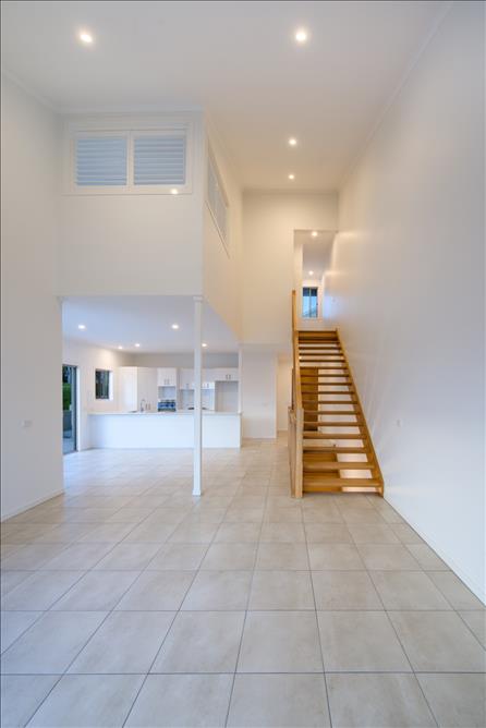 Home Design Internal. Lounge, Kitchen and looking up to internal stairs to top level.